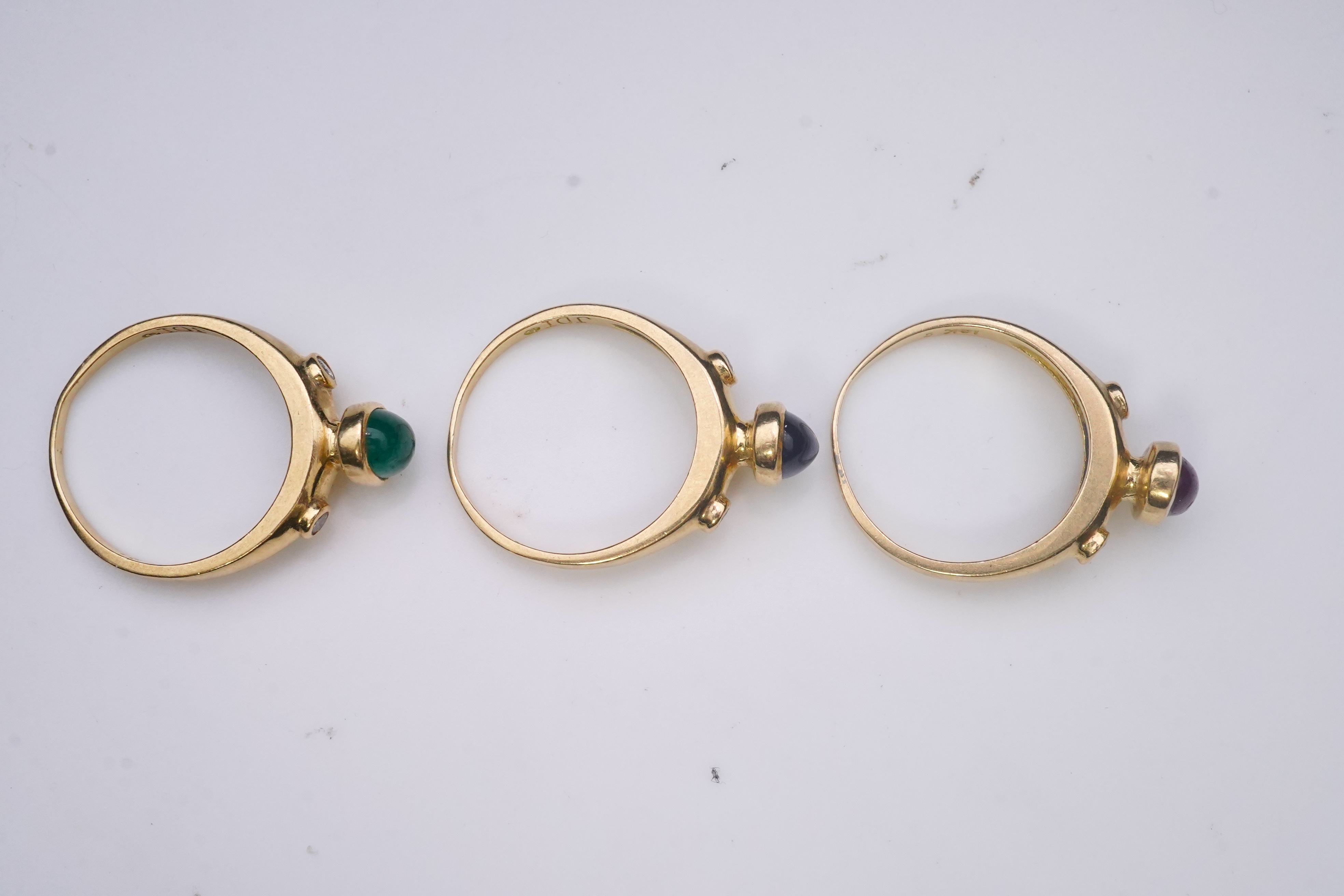 A suite of three gold and gem-set rings